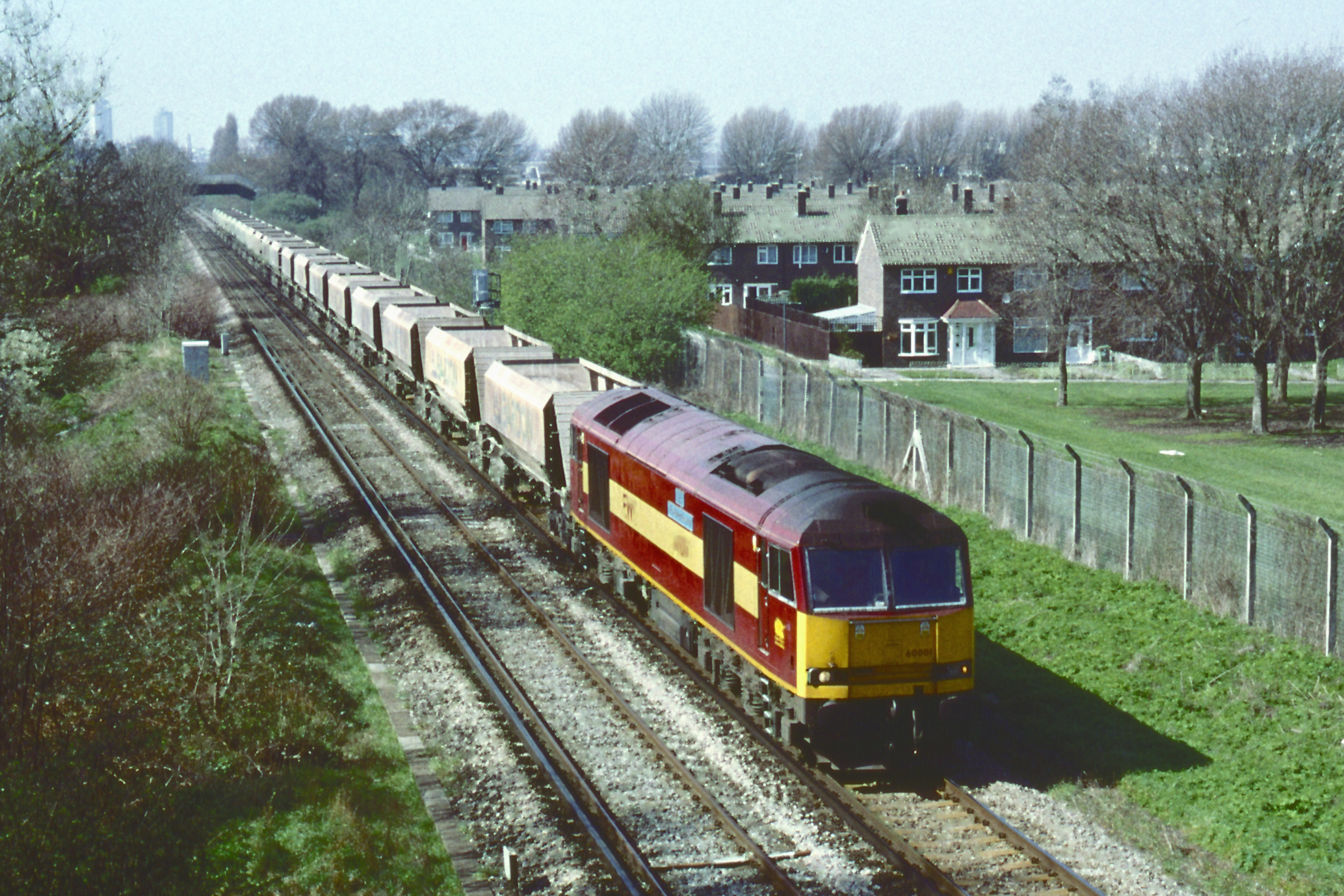 60001 passes Abbey Wood station on 31st March 2004 with the Tolworth to Cliffe empty stone hoppers. David Clark, courtesy Rodney Lissenden