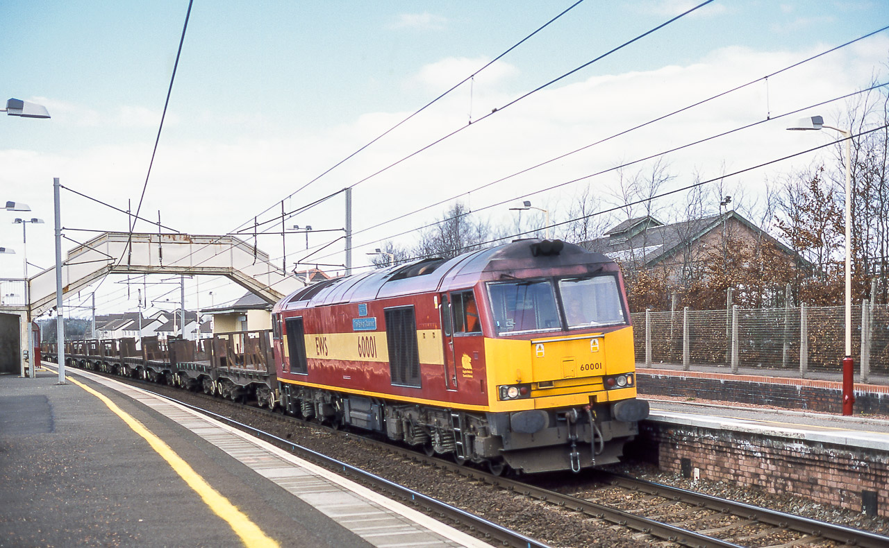 60001 passing through Carluke station. The wagons would suggest that the working is 6E30, Dalzell - Lackenby empty steel, a regular Class 60 working in those days. 16th April 2001. Keith Sanders