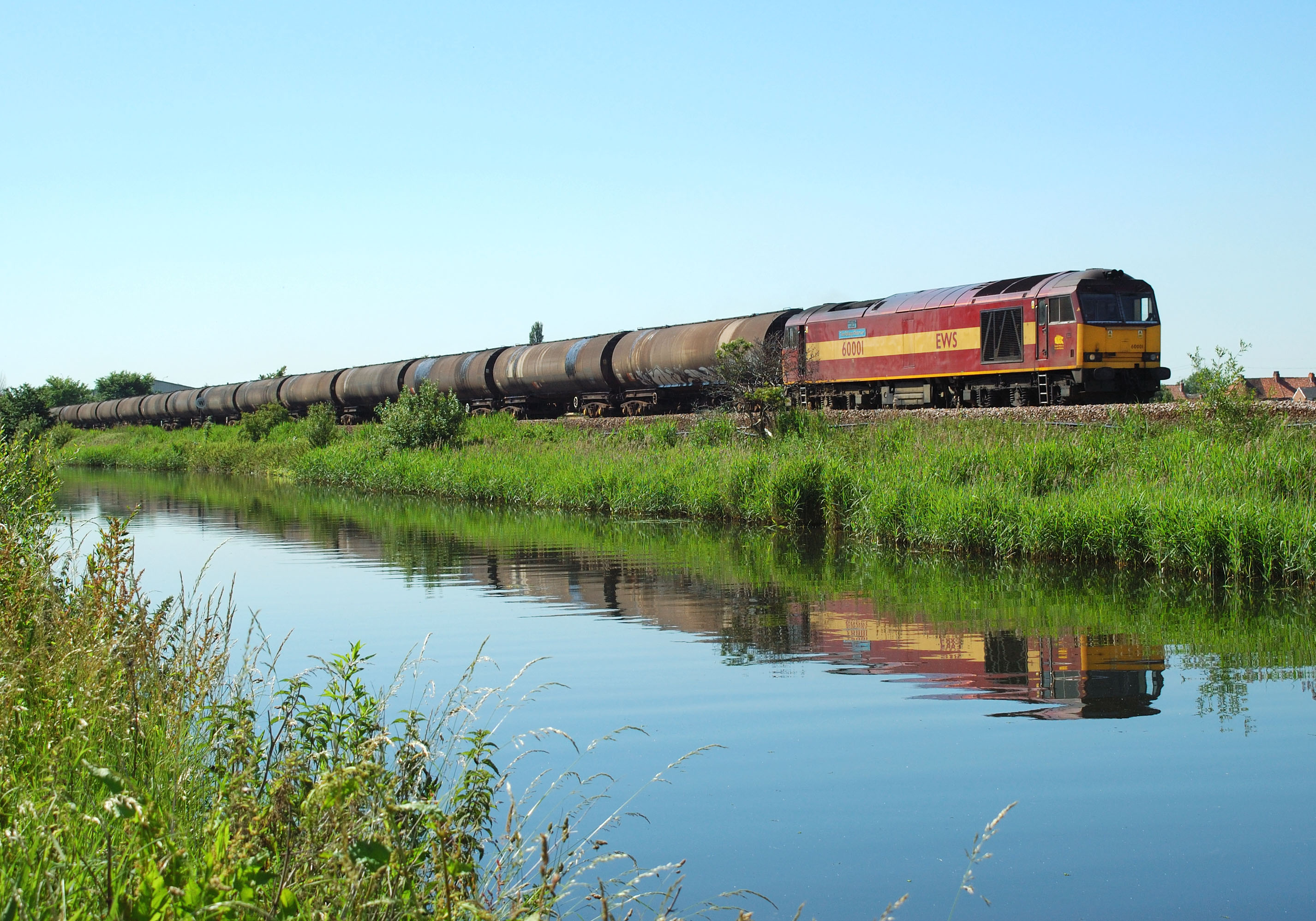 And a few hours later 60001 runs alongside the Stainforth & Keadby canal at Crowle with 6E32 Preston Docks to Lindsey empty bitumen tanks, 27th June 2005. Julie Knowles