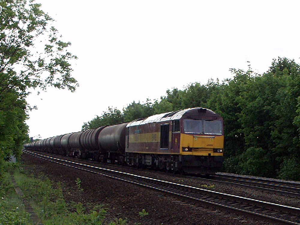 60001 heading west at Croxton, between Immingham and Barnetby, with 6N04 Lindsey to Jarrow loaded bogie oil tanks, 21st May 2004. David Neville