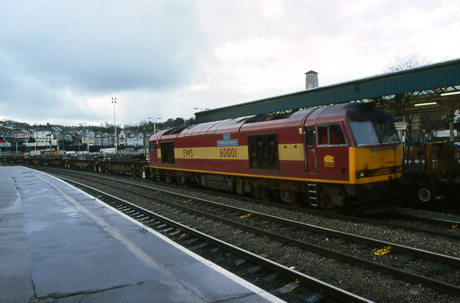 60001 at Newport station on a wet day with 6M86 Margam to Dee Marsh loaded steel, 22nd November 2002. Brian Garrett