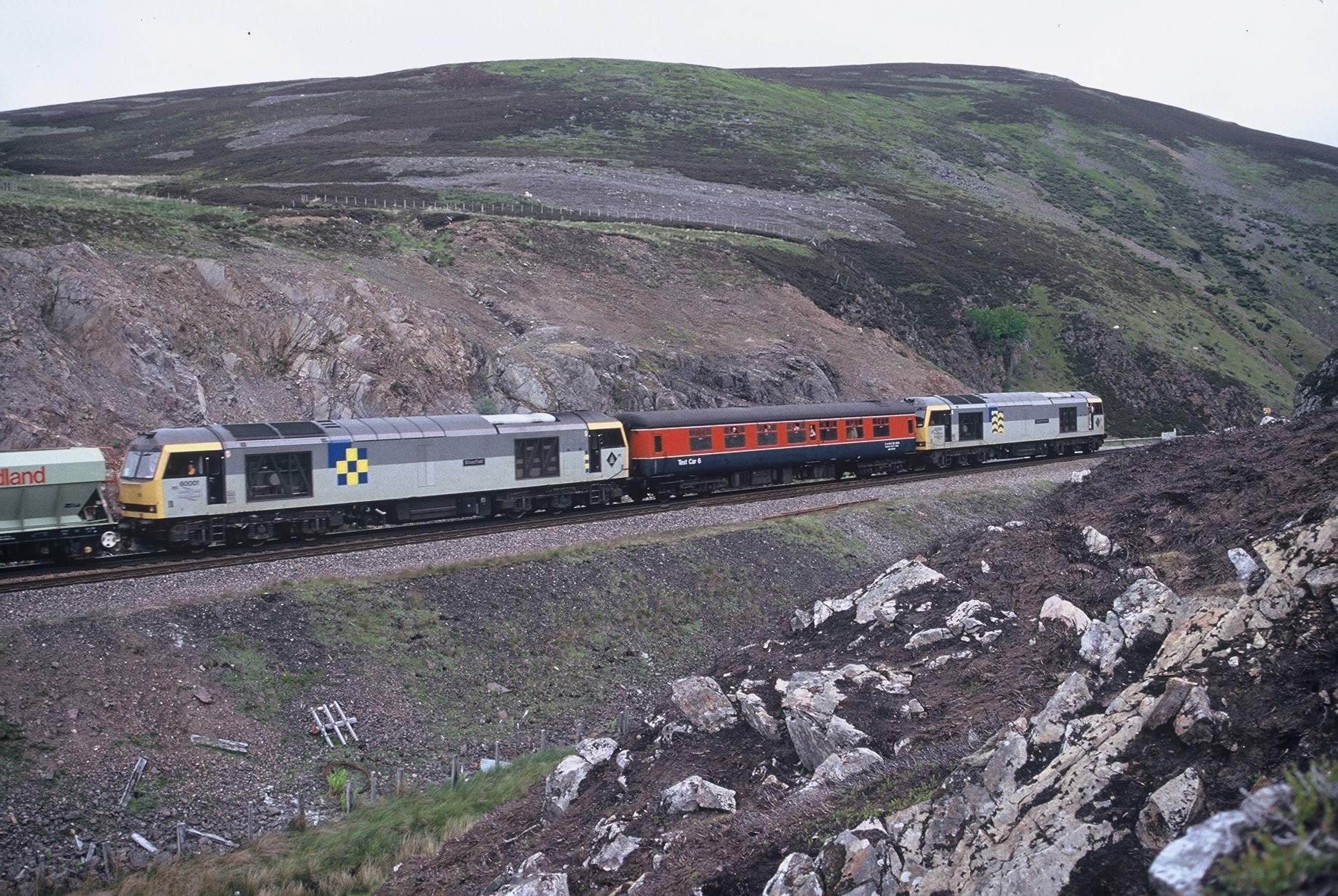 60002 leading Test Car 6, 60001 and a rake of Redland hoppers approaching Sloch’d summit, 10th June 1990. Robin Ralston